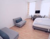 a bedroom with a bed and desk in a room a bedroom with a bed and desk in a room
